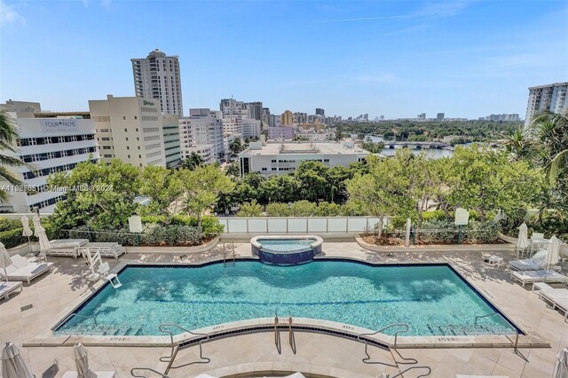 4401 Collins Ave Unit 1214, Miami Beach, FL 33140 - view of swimming pool with a patio area, a skyline view, and a pool with connected hot tub