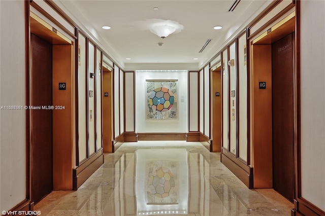 hall featuring ornamental molding and elevator