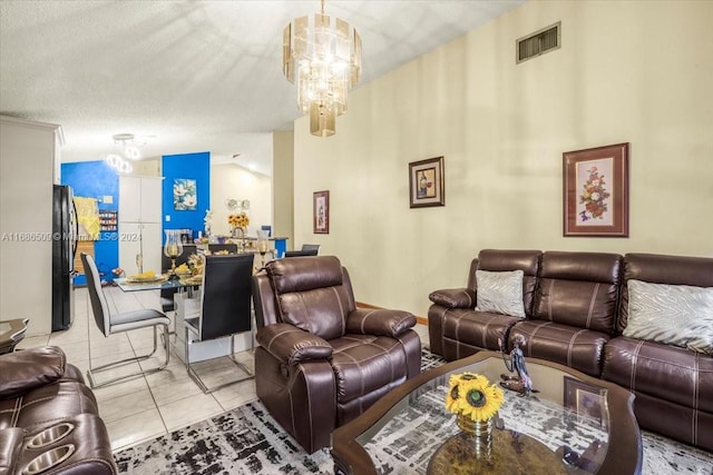 tiled living room with lofted ceiling, a textured ceiling, and an inviting chandelier