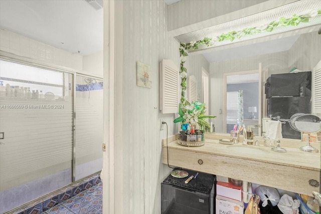 bathroom featuring vanity, plenty of natural light, and an enclosed shower