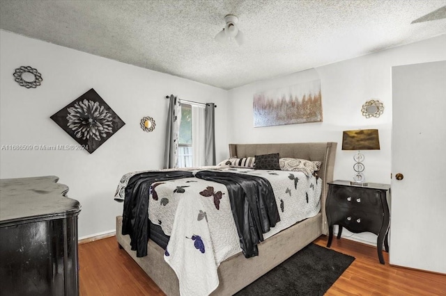 bedroom featuring a textured ceiling and wood-type flooring