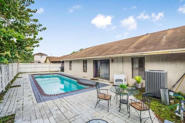 view of pool with a patio area and central AC