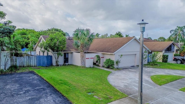 view of front facade with a front yard and a garage