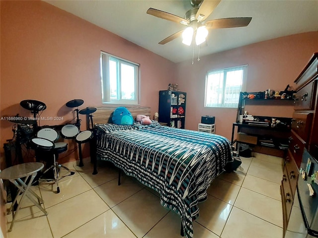 tiled bedroom with multiple windows and ceiling fan