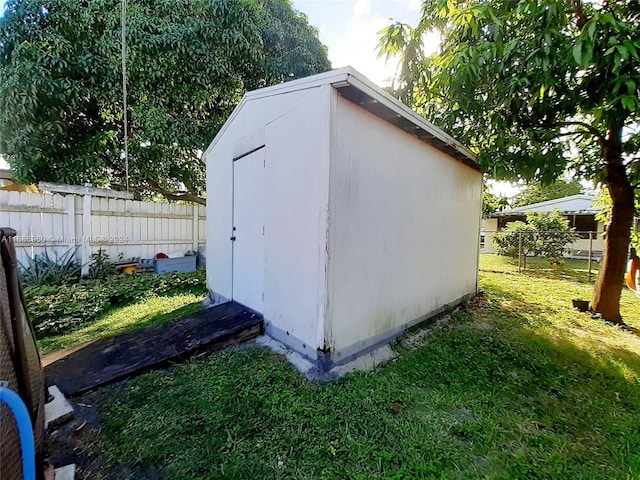 view of outdoor structure featuring a lawn