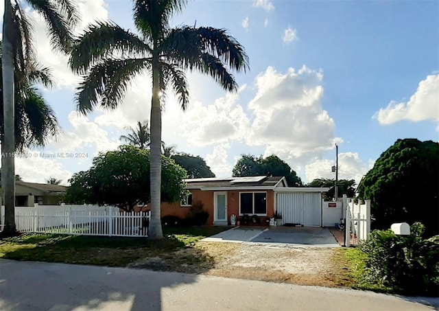 view of front facade featuring solar panels