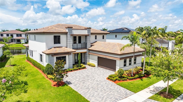 view of front of home featuring a front yard and a garage