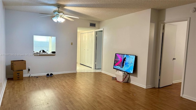 unfurnished room featuring light hardwood / wood-style floors and a textured ceiling