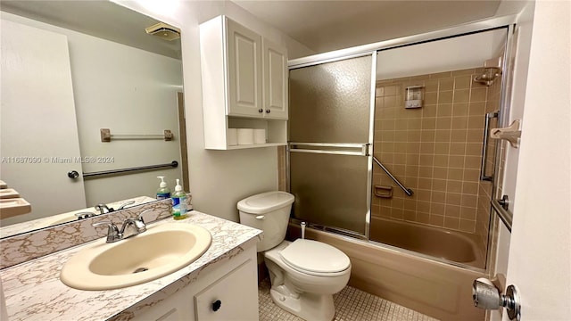 full bathroom with tile patterned flooring, vanity, toilet, and enclosed tub / shower combo