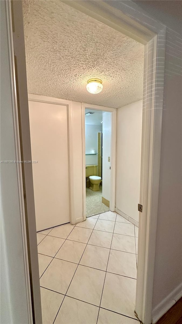 corridor featuring light tile patterned floors