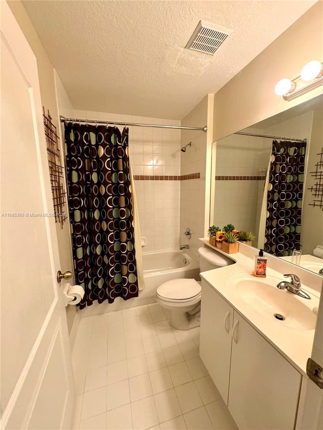 full bathroom with tile patterned floors, a textured ceiling, toilet, vanity, and shower / tub combo