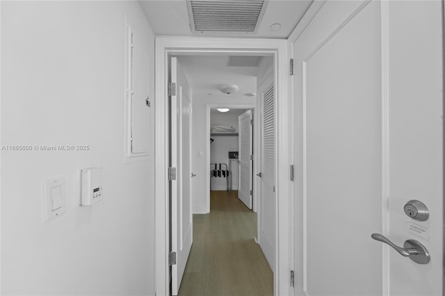 hallway with hardwood / wood-style flooring