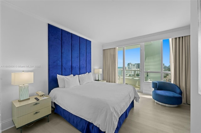 bedroom with hardwood / wood-style flooring and ornamental molding