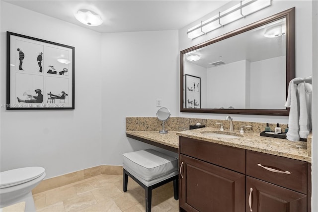 bathroom with vanity and toilet