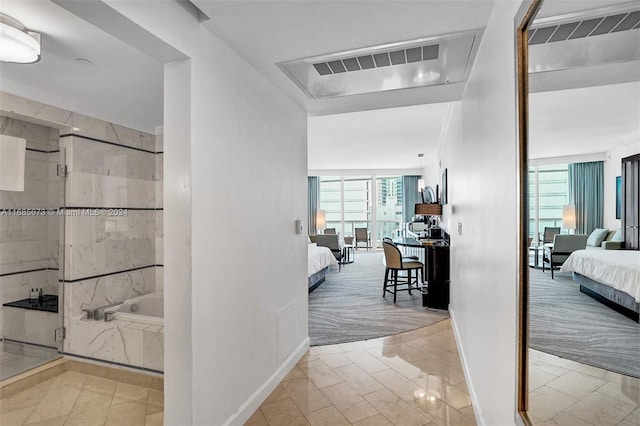 hall with plenty of natural light and floor to ceiling windows