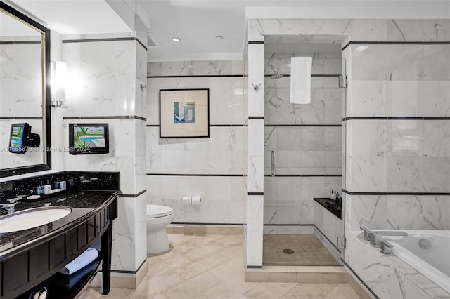 full bathroom featuring vanity, tile walls, toilet, and separate shower and tub