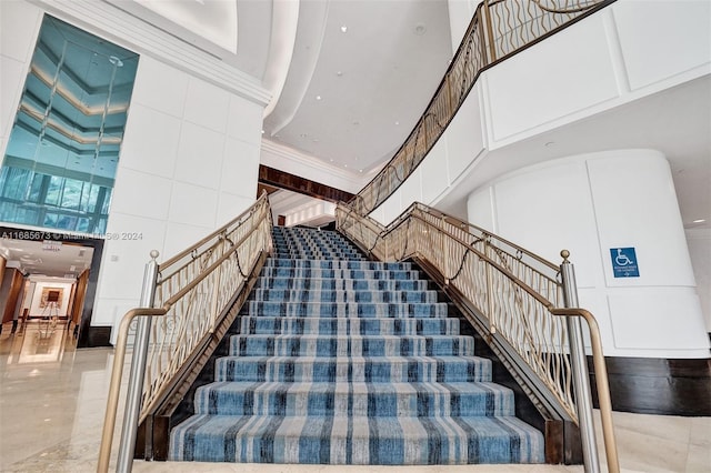 stairs featuring a high ceiling