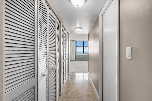 corridor featuring light tile patterned floors