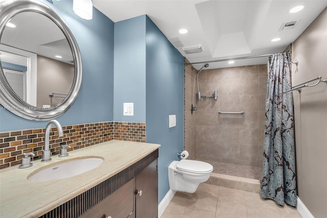 bathroom with toilet, vanity, tile patterned floors, and curtained shower