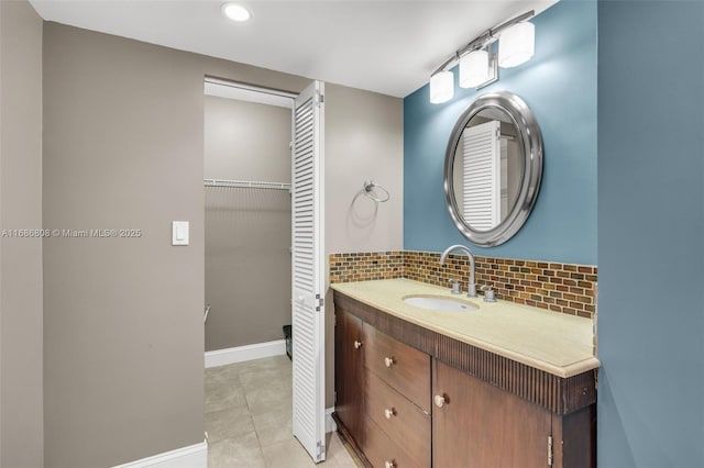 bathroom featuring decorative backsplash, vanity, and tile patterned floors