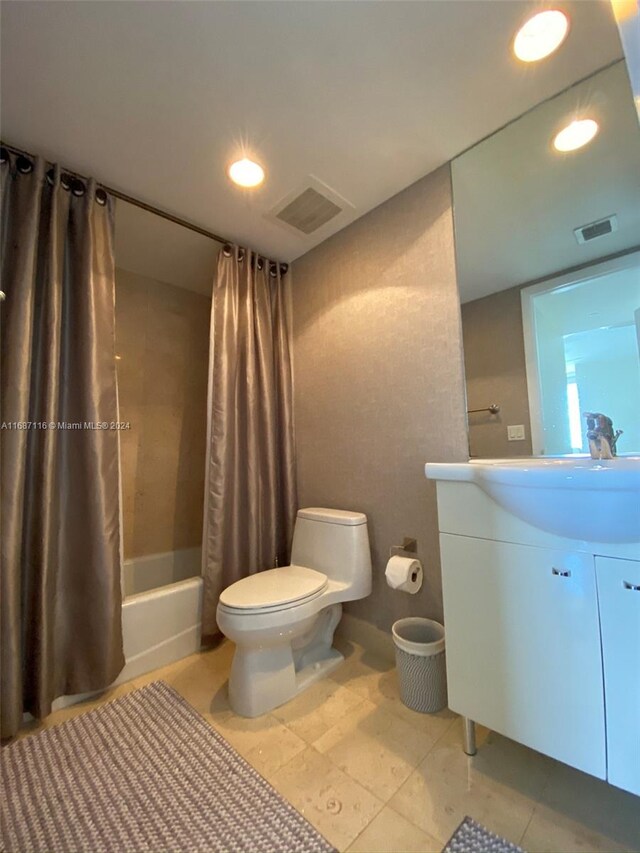 full bathroom featuring vanity, toilet, and shower / bathtub combination with curtain