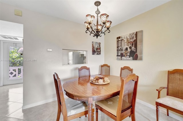 dining room with a notable chandelier and light tile patterned floors