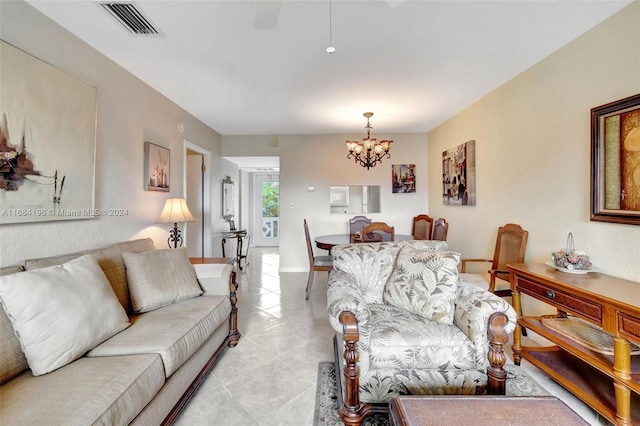 living room with light tile patterned flooring and an inviting chandelier