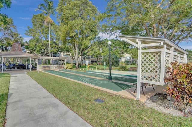 5103 NW 35th St Unit 607, Lauderdale Lakes, FL 33319 - view of community featuring shuffleboard, a gazebo, and a lawn