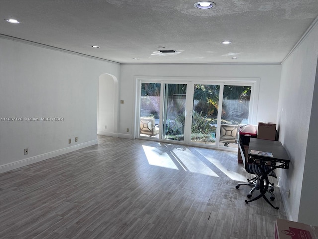 office space with a textured ceiling, hardwood / wood-style flooring, and ornamental molding