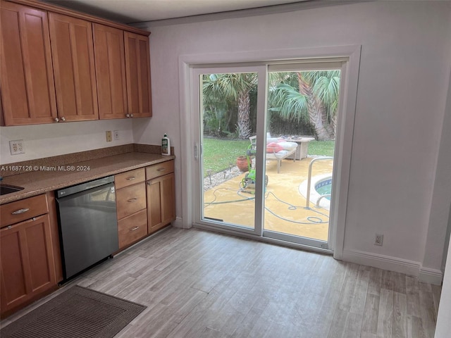 kitchen featuring light hardwood / wood-style floors and stainless steel dishwasher