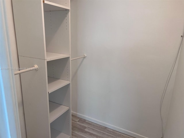 walk in closet featuring light hardwood / wood-style flooring