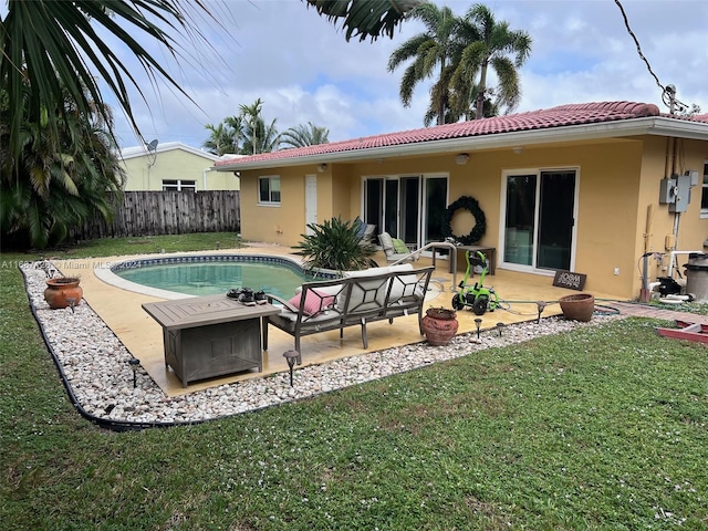 rear view of property featuring a lawn, a fenced in pool, and a patio