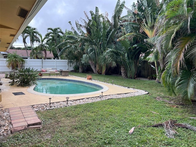 view of pool featuring a yard and a patio