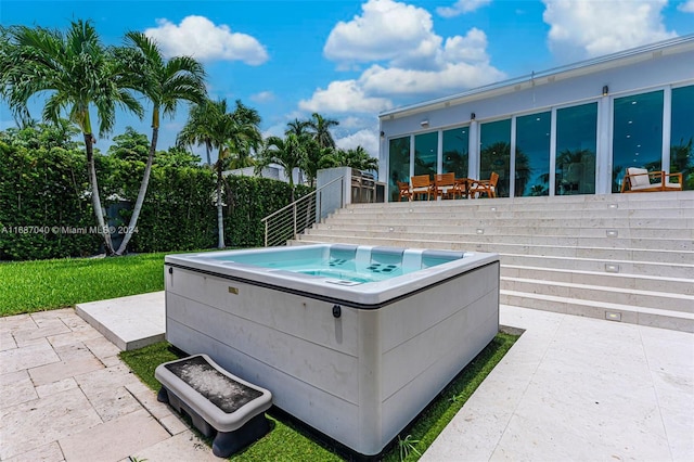 view of swimming pool featuring a patio area and a hot tub