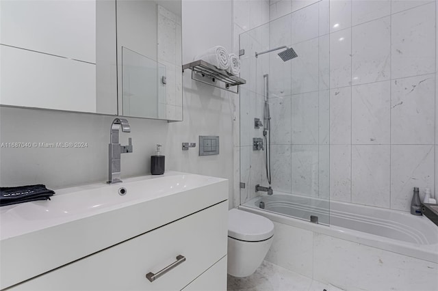 full bathroom featuring vanity, tiled shower / bath combo, and toilet