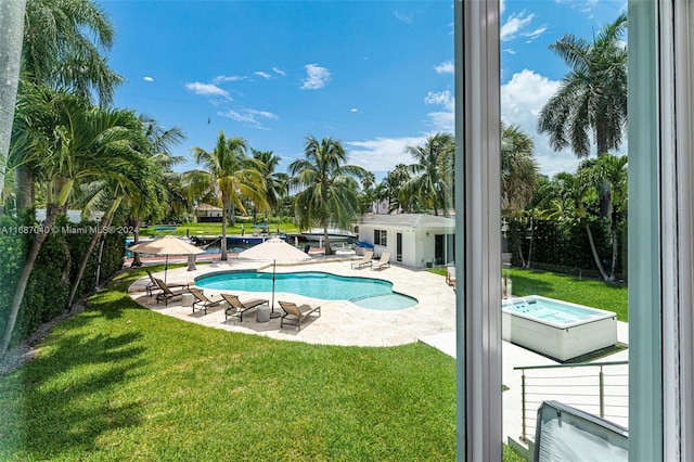 view of swimming pool with a yard and a patio area