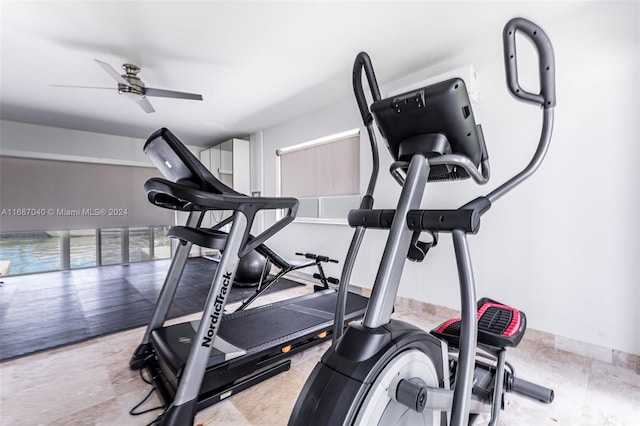 exercise room with ceiling fan