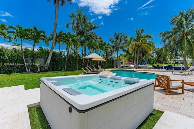 view of pool with a patio and a hot tub