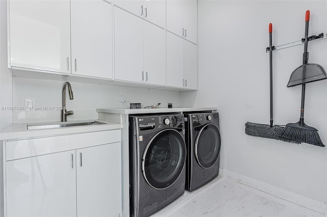 laundry room with cabinets, separate washer and dryer, and sink