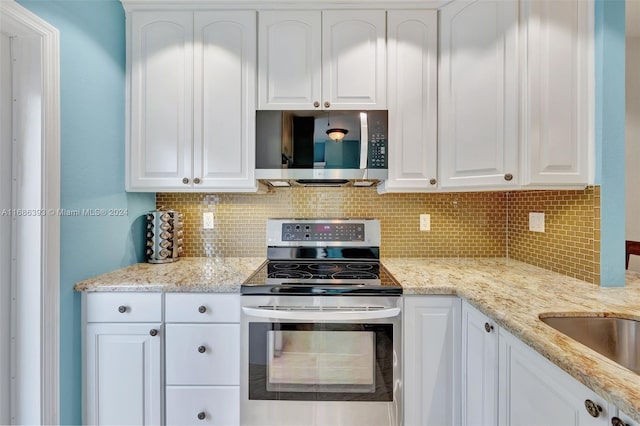 kitchen featuring white cabinetry, decorative backsplash, and appliances with stainless steel finishes