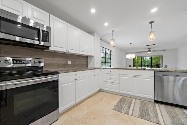 kitchen with ceiling fan, backsplash, decorative light fixtures, white cabinets, and appliances with stainless steel finishes