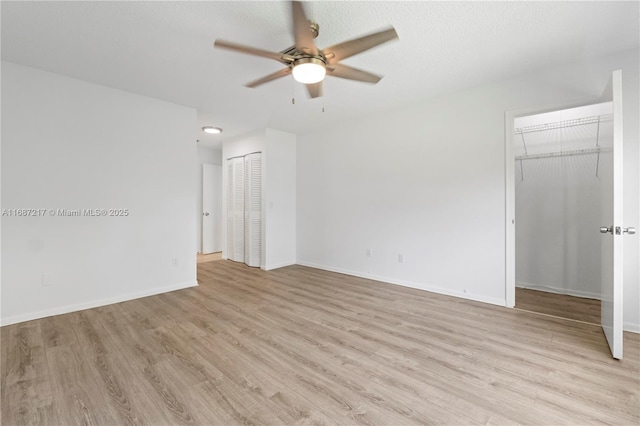 unfurnished room with ceiling fan and light wood-type flooring