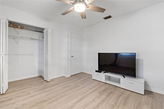 unfurnished bedroom with ceiling fan, a closet, and light wood-type flooring