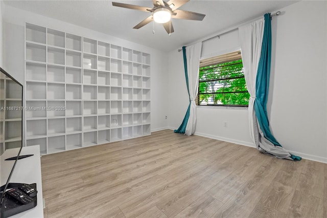 spare room featuring light hardwood / wood-style floors and ceiling fan