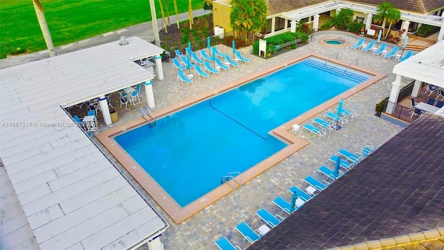 view of pool with a hot tub