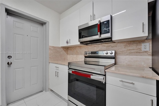 kitchen featuring white cabinetry, stainless steel appliances, and tasteful backsplash