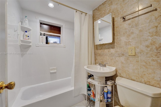 bathroom with toilet, shower / tub combo with curtain, and tile walls