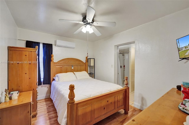 bedroom featuring ceiling fan, light wood-type flooring, and a wall mounted air conditioner