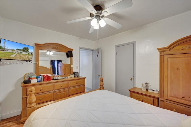 bedroom with light hardwood / wood-style flooring and ceiling fan