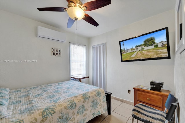 tiled bedroom featuring a wall mounted air conditioner and ceiling fan